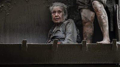 An elderly survivor is transported to a safer place in heavy machinery following flash flood and mudslide at Trishuli in Nuwakot district, Nepal. Reuters