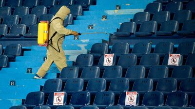 A worker disinfects the stands during the closed-door Copa Libertadores group phase football match between Colombia's Junior and Ecuador's Independiente del Valle, at the Roberto Melendez Stadium in Barranquilla, Colombia. AFP