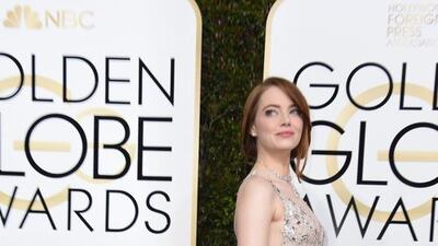 Emma Stone expertly paired a Valentino gown with Jimmy Choo shoes and Tiffany jewels. Valerie Macon / AFP