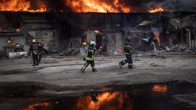 Firefighters work to extinguish flames at a warehouse hit by Russian shelling in Kharkiv in 2022. Getty Images