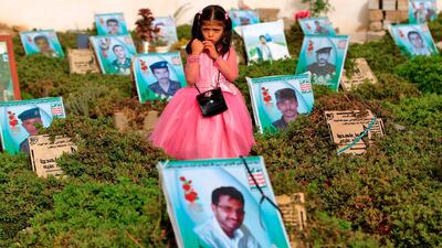A Yemeni girl stands near the grave of a relative in a cemetery in the capital Sanaa. Mohammed Huwais / AFP