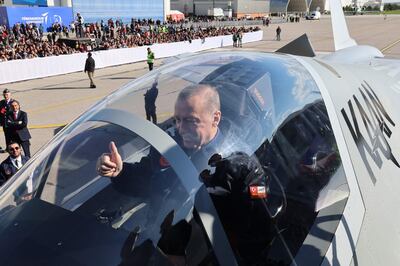 Turkish President Recep Tayyip Erdogan sits in the cockpit of Turkey's national combat aircraft TF-X at the Turkish Aerospace Industries Headquarters in Ankara. AFP
