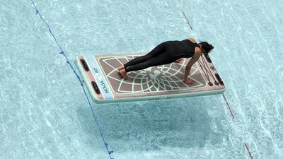 The Boga Fitmat boards include foot loops for sit-ups, resistance bands for strengthening, and can be used for aerobic workouts, yoga and more. The classes at FloatUAE also include the use of small weights and balls. Chris Whiteoak / The National