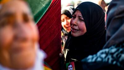 Relatives mourn at a funeral for two Syrian Democratic Forces (SDF) fighters in the Syrian Kurdish-majority city of Qamishli, after they were killed by a Turkish military drone, according to Kurdish security officials. AFP