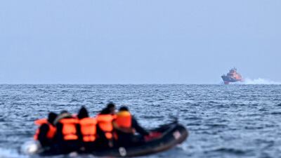 Royal National Lifeboat Institution (RNLI) Severn class lifeboat, the City of London II, makes its way towards migrants travelling in an inflatable boat across the English Channel, bound for Dover on the south coast of England. More than 45,000 migrants arrived in the UK last year by crossing the English Channel on small boats. AFP