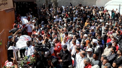 Palestinians grieve for medics killed by Israeli fire while on a rescue mission in Khan Younis, southern Gaza. Reuters