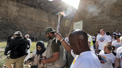Allen Jones holding the Special Olympics torch “Flame of Hope” in Wadi Al Wurayah Waterfalls in Fujairah. Pawan Singh/The National