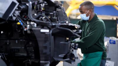 A worker carries out checks on a Range Rover.