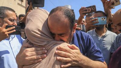 Gaza's Al Shifa Hospital director Mohammed Abu Salmiya is embraced by relatives after his release from Israeli incarceration. AFP