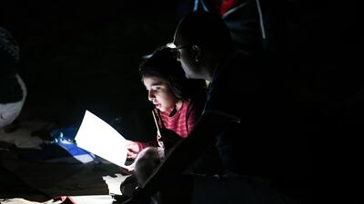 Abu Dhabi, United Arab Emirates - Young children participate in singing Christmas carols by candlelight in the desert. Khushnum Bhandari for The National
