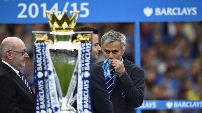 Chelsea manager Jose Mourinho kisses his medal in front of the trophy after winning the Premier League. Reuters / Dylan Martinez