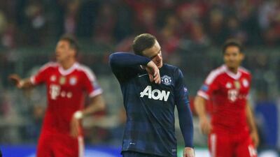 Manchester United's Wayne Rooney, centre, reacts after the Uefa Champions League quarter-final second leg against Bayern Munich on April 9, 2014. Michael Dalder / Reuters