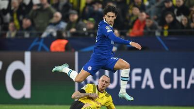 Chelsea's Joao Felix is challenged by Marius Wolf. Getty