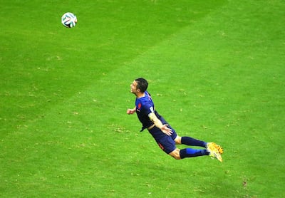 Robin van Persie of the Netherlands scores the team's first goal with a diving header during the 2014 Fifa World Cup Group B match with Spain. Getty