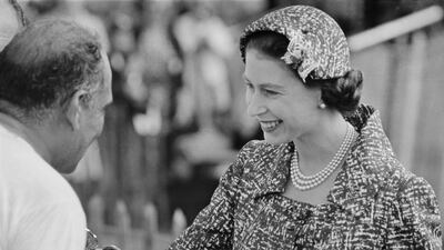 Britain's Queen Elizabeth II attends a Windsor polo match wearing a three-strand pearl necklace in 1958. Getty Images