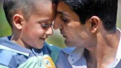 Sahil Saeed, five, who was kidnapped on March 3 while on holiday in Pakistan, with his father Raja Naqqash at the British High Commission in Islamabad yesterday.