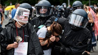 Police arrest a protester during a march against Covid-19 restrictions in Berlin. AP