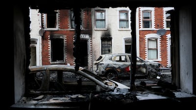 Damaged cars and buildings after anti-immigrant protests following a knife attack that left a man seriously injured, in East Belfast, Northern Ireland. Reuters