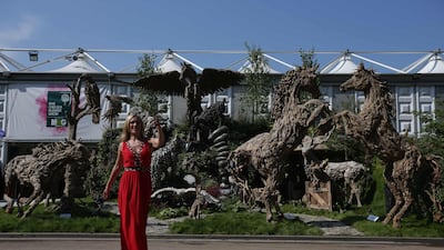 A visitor walks by Driftwood Sculptures by James Doran Webb.