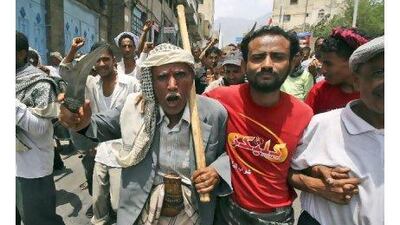 A protester brandishes his dagger during a demonstration calling for Ali Abdullah Saleh to quit in Taiz on Saturday. Anees Mahyoub / AP Photo