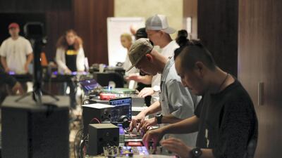 DJs rehearse playing in unison before the performance this weekend. Chris Whiteoak / The National