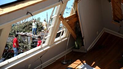 Thunderstorms and tornadoes in May in the US generated losses of $1.7 billion, with $1.1bn of that covered. Above, residents salvage what they can from a home that was destroyed by a tornado in Mississippi. Joe Raedle / Getty Images / AFP