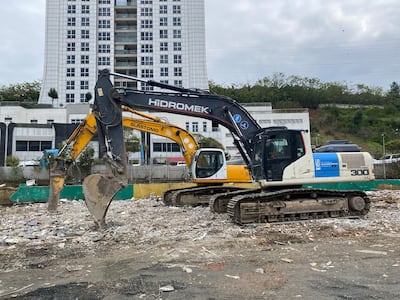 Diggers clear damaged earth next to the Ayazaga Creek after torrential rain caused flooding. Lizzie Porter / The National