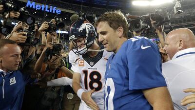 Peyton Manning, left, and Eli, his younger brother, are unlikely to play against each other ever again. Frank Franklin II / AP Photo
