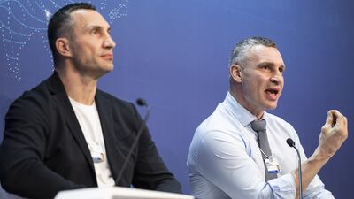 Vitali Klitschko, right, and his brother Wladimir speak to the World Economic Forum in Davos. EPA