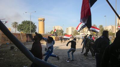 Militia members and their supporters remained camped outside the embassy despite tear gas and stun grenades fired at them on Wednesday. AFP