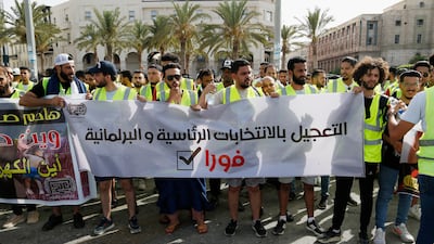 Protesters in Tripoli calling for elections in July 2022. The banner reads: 'Acceleration of the presidential and parliamentary elections now.' AP