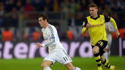 Borussia Dortmund' player Lukasz Piszczek and Real Madrid player Gareth Bale in action during Tuesday night's Champions League match. Federico Gambarini / EPA / April 8, 2014