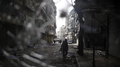 A fighter from the Al Qaeda-linked Syrian rebel group Jabhat Al Nusra is seen through a smashed bus window during a fight with forces loyal to President Bashar Al Assad at the front line in Aleppo on December 24, 2012. Ahmed Jadallah/Reuters