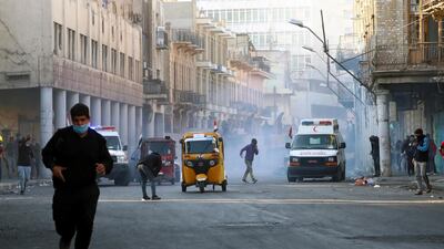 Demonstrators run from tear gas. Reuters
