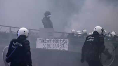 A police line near a statue of Robert Schuman, first president of the European Parliament, during the European Demonstration for Democracy protest. Bloomberg
