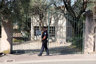 A police officer stands guard at the entrance of the Musee Renoir after the robbery. AFP