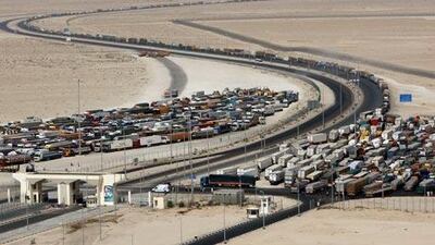 Transport trucks wait in line at the UAE / Saudi Arabia border crossing.