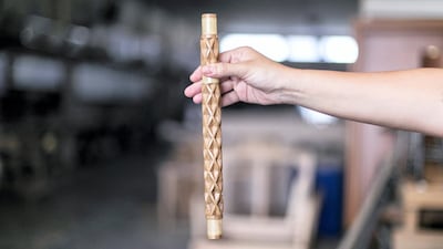 Lana El Samman holds a sample of her table’s leg, which has been intricately hand-carved by manufacturers at Aden Furniture & Wood Factory in Sharjah
