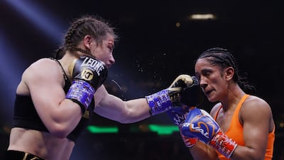 Katie Taylor connects with a left punch on Amanda Serrano. AFP