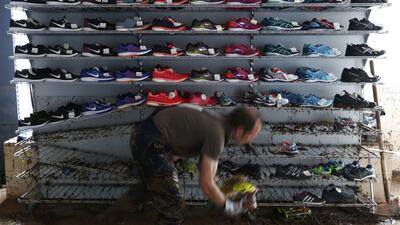 A worker clears flood damage at Intersport Schoell sporting goods store in the town of Schwaebisch Gmuend near Stuttgart, Germany. Michaela Rehle / Reuters