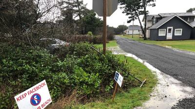 A sign expressing opposition to a plan by Facebook to build a landing spot for a submarine cable connecting America with Asia stands on property in the tiny community of Tierra del Mar in Oregon. AP