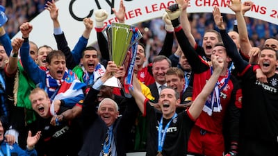 Rangers manager Walter Smith (and team captain David Weir hoist the 2020/11 Scottish Premier League trophy on May 15, 2011. Reuters