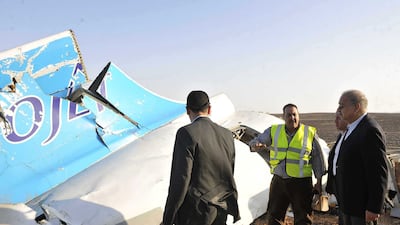 Egyptian Prime Minister Sherif Ismail, right, looks at the remains of the crashed passenger jet in Hassana, Egypt on Saturday. The prime minister said experts had confirmed that the militants could not down a plane at the 9,000 metre altitude the Airbus A321 was flying. Suliman el-Oteify / Egyptian Prime Minister’s Office via AP