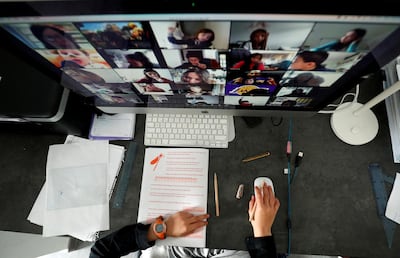 A student takes online classes with his companions using Zoom in Barcelona. Reuters