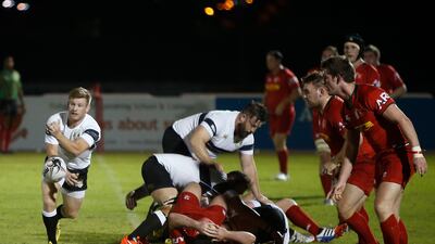 DUBAI - UNITED ARAB EMIRATES - 07OCT2016 - Dubai Exiles and Bahrain (in red) tussels for the ball in the West Asia Premiership rugby match yesterday at The Sevens, rugby grounds in Dubai. Ravindranath K / The National (to go with Paul Radley story for Sports) ID: 74521 *** Local Caption *** RK0710-Rugby10.jpg