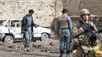 International and Afghanistan security forces patrol after a suicide bomber killed a policeman in the southern Afghan city of Kandahar on Monday.