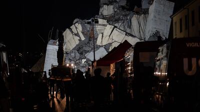 Emergency personnel search through debris from the collapsed Morandi motorway bridge. Bloomberg