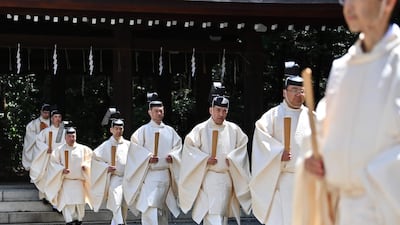 Shinto priests walk towards the main building to conduct a festive ceremony to report the enthronement of the new emperor to the royal family's ancestors at Meiji Shrine in Tokyo.. Japan's new Emperor Naruhito formally ascended the Chrysanthemum Throne, a day after his father abdicated from the world's oldest monarchy and ushered in a new imperial era. AFP