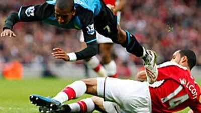 Ashley Young is sent flying by Theo Walcott to earn a penalty which he took himself and missed.