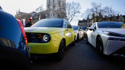 A range of electric automobiles parade through Westminster in central London. Getty Images